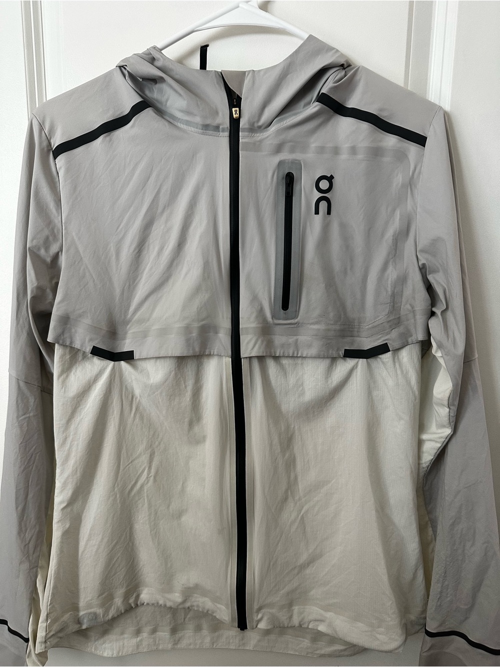On Running Two-Tone Hooded Rain Jacket in Light Gray and Off-White
